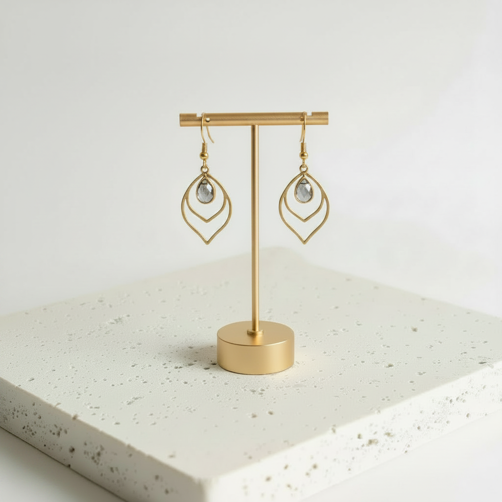 Dusk smoky grey faceted glass teardrop earrings in gold, shown hanging