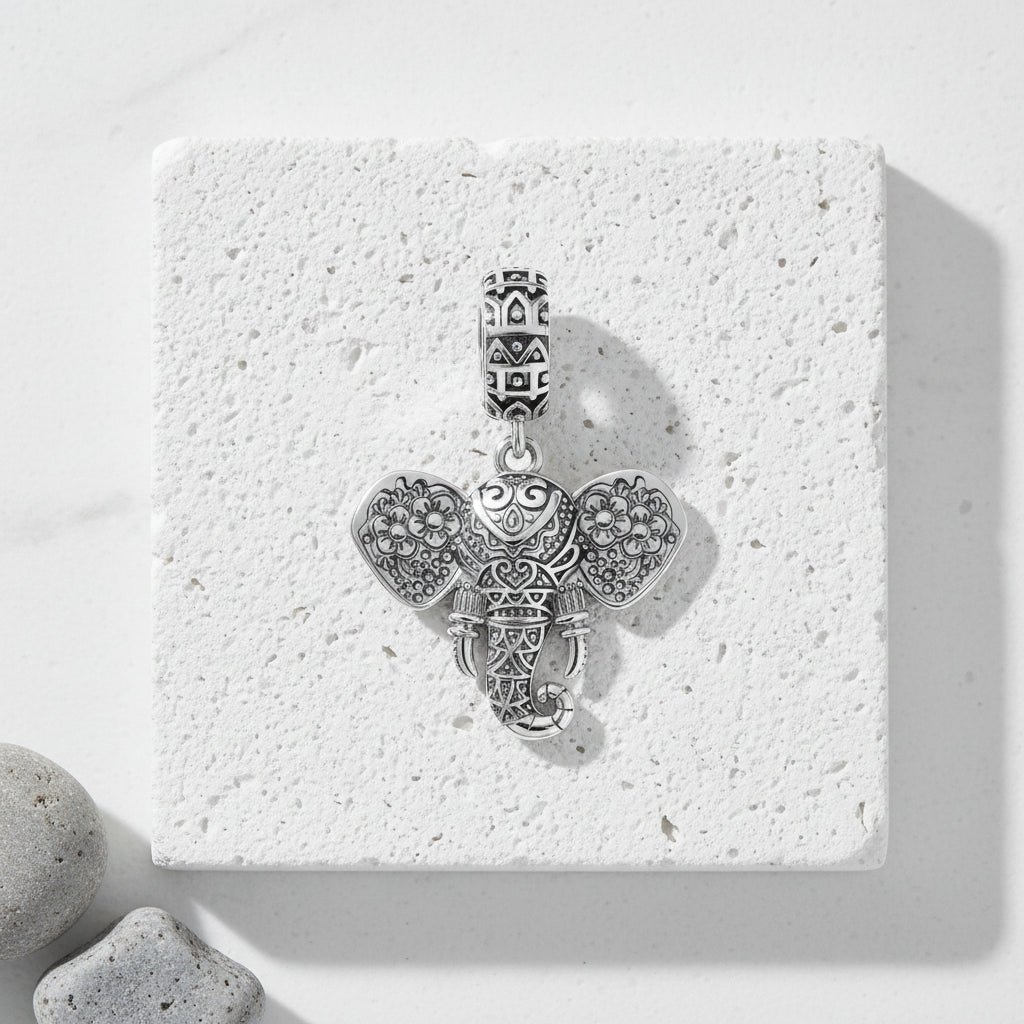Close-up of the fine flower detail on a sterling silver elephant charm pendant