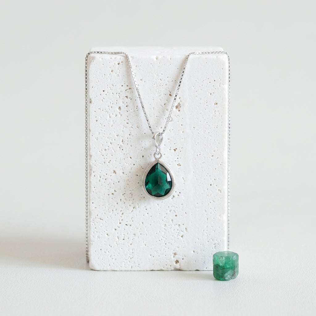 Silver teardrop pendant necklace with emerald green faceted glass drop, May birthstone colour