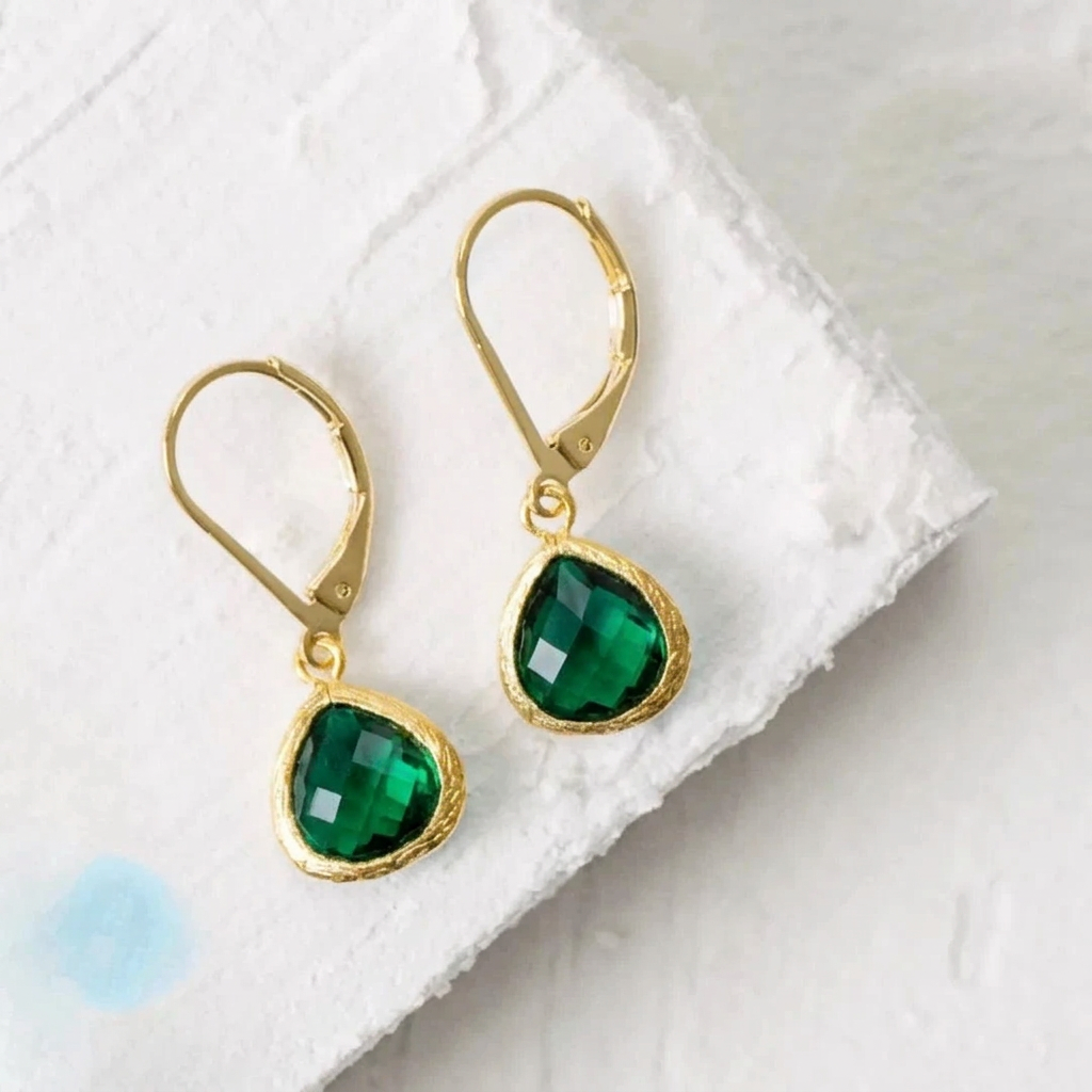 Gold Petite Pebble leverback earrings in emerald green faceted glass, May birthstone colour