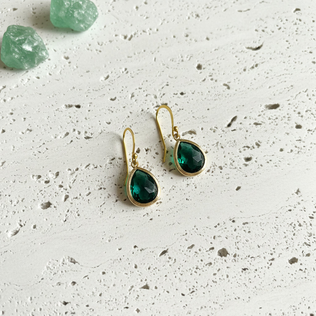 Emerald green faceted glass drop earrings in gold plated brass