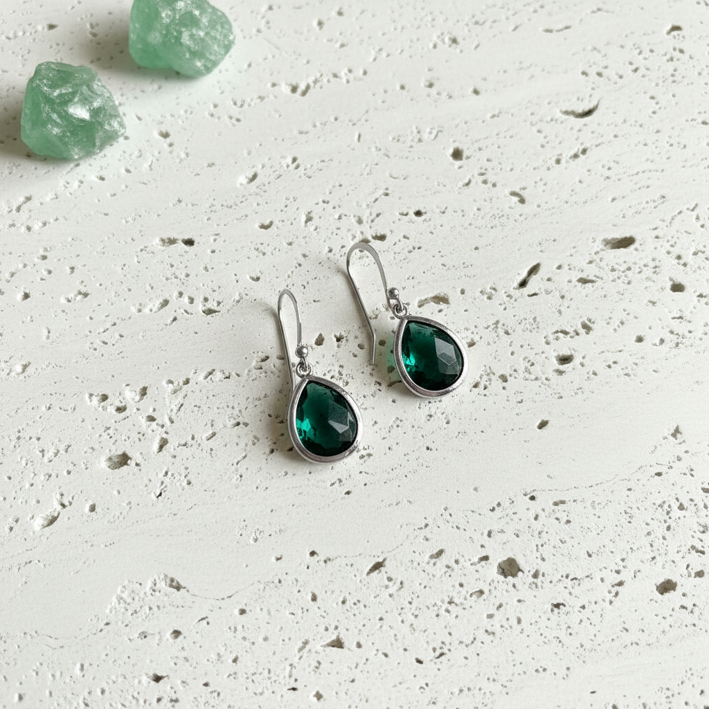 Emerald green faceted glass drop earrings in silver plated brass