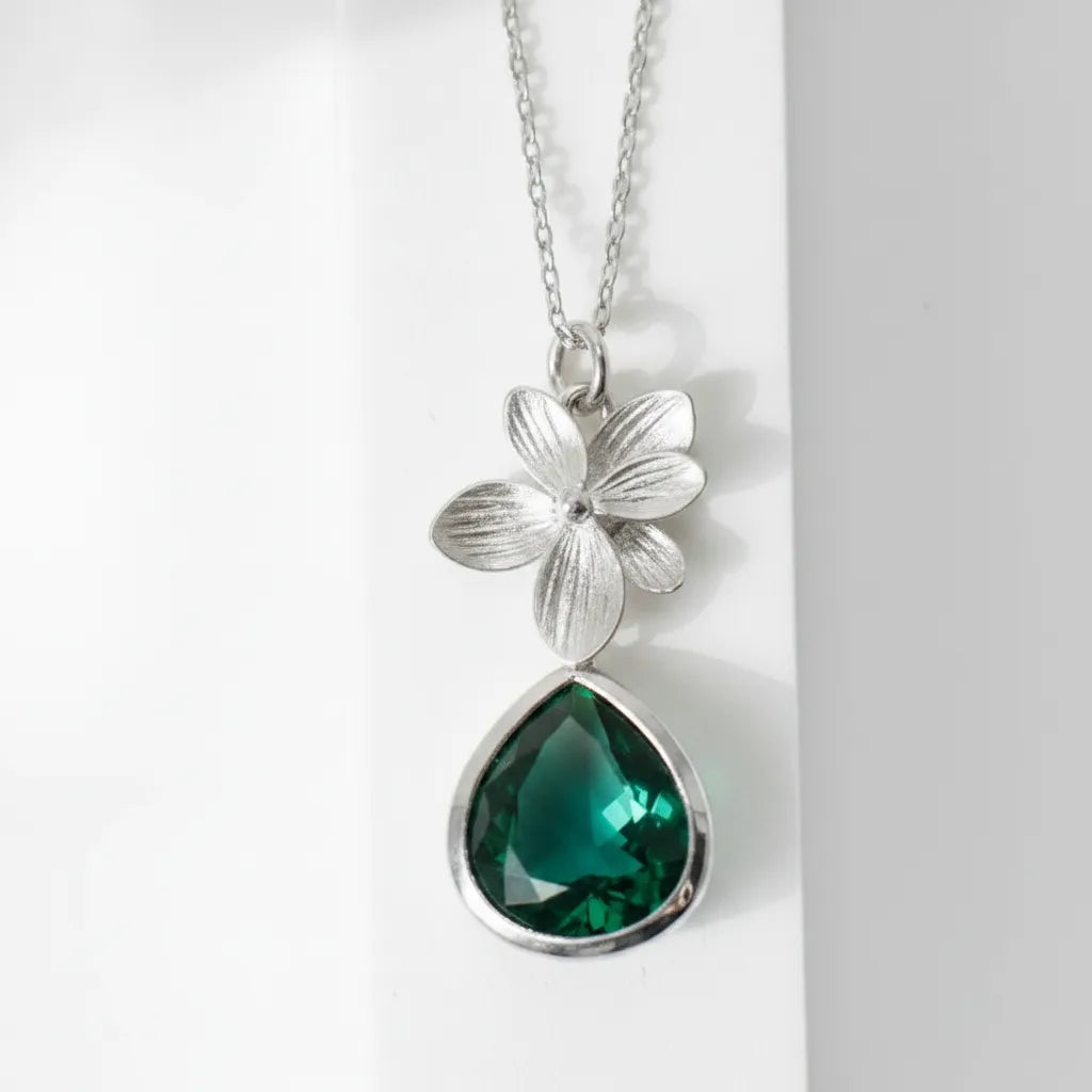 Silver plated orchid glass drop necklace with an emerald green faceted drop