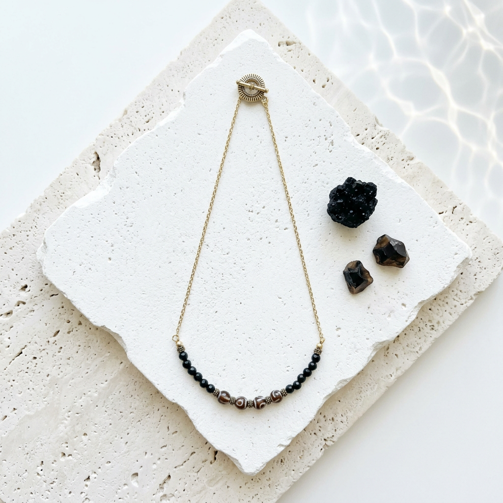 Etched agate dzi-style necklace with onyx and brass beads, full view