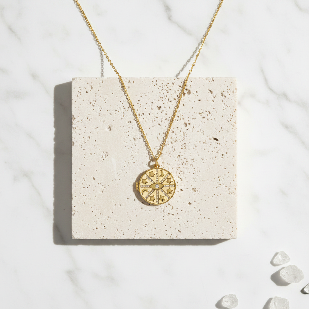 Gold cut-out evil eye pendant necklace flat lay — protection talisman jewelry