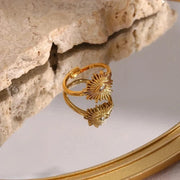 Gold ring with shell design on a reflective surface
