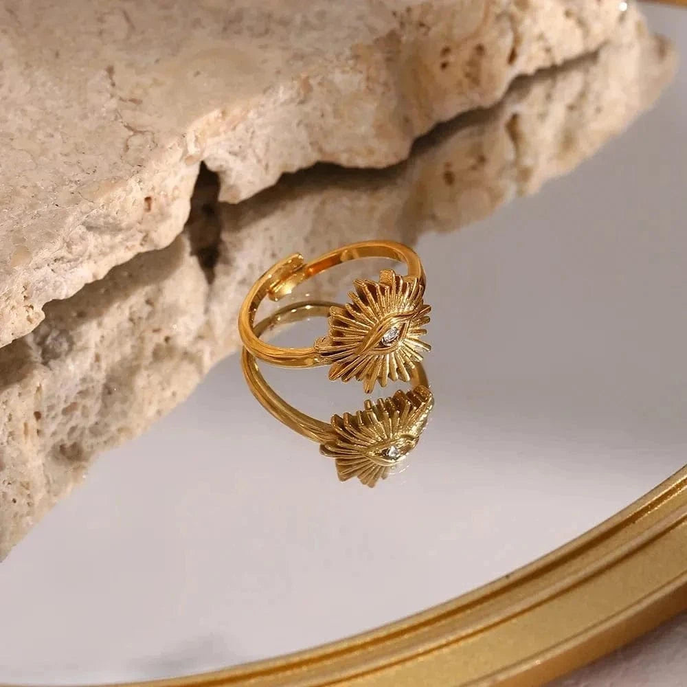 Gold ring with shell design on a reflective surface