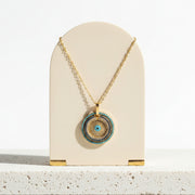 Pave blue and gold evil eye pendant necklace hanging — protection talisman jewelry