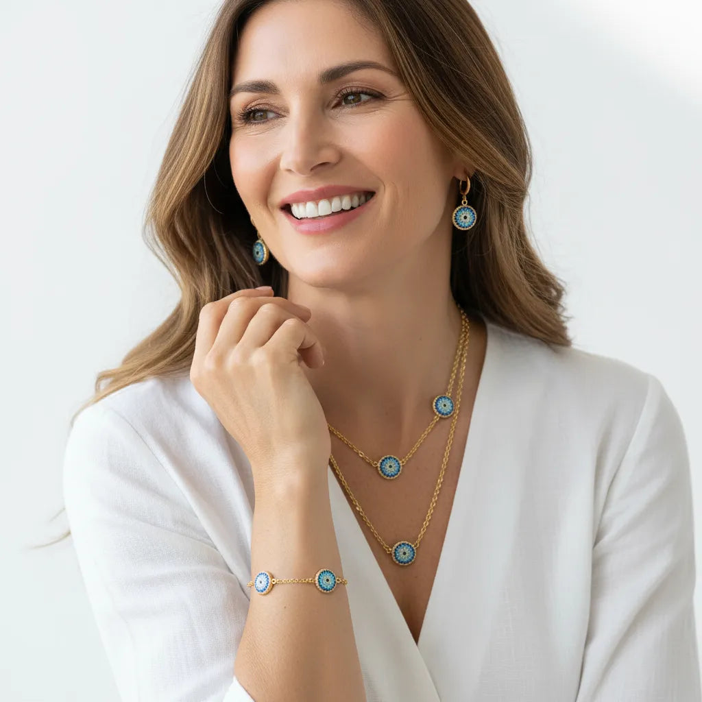 Gold round evil eye bracelet, earrings and necklace set with blue crystals — protection symbol jewelry