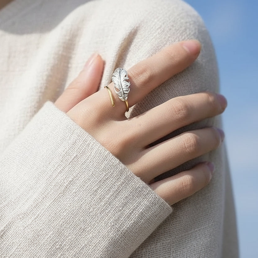Gold feather ring worn on the hand — spiritual symbol jewelry for guidance and freedom