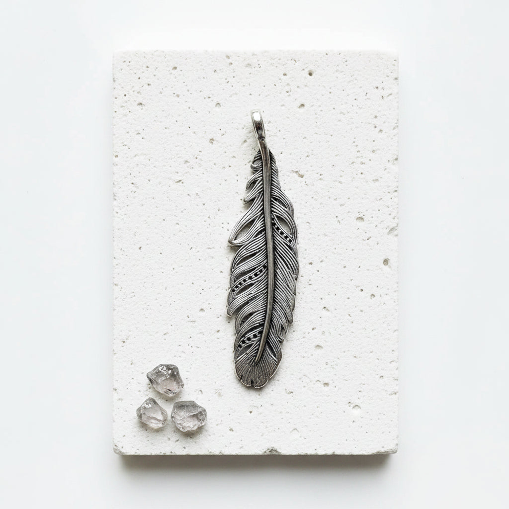 Reverse of the blackened sterling silver feather pendant showing the 925 hallmark — air element jewellery for transformation