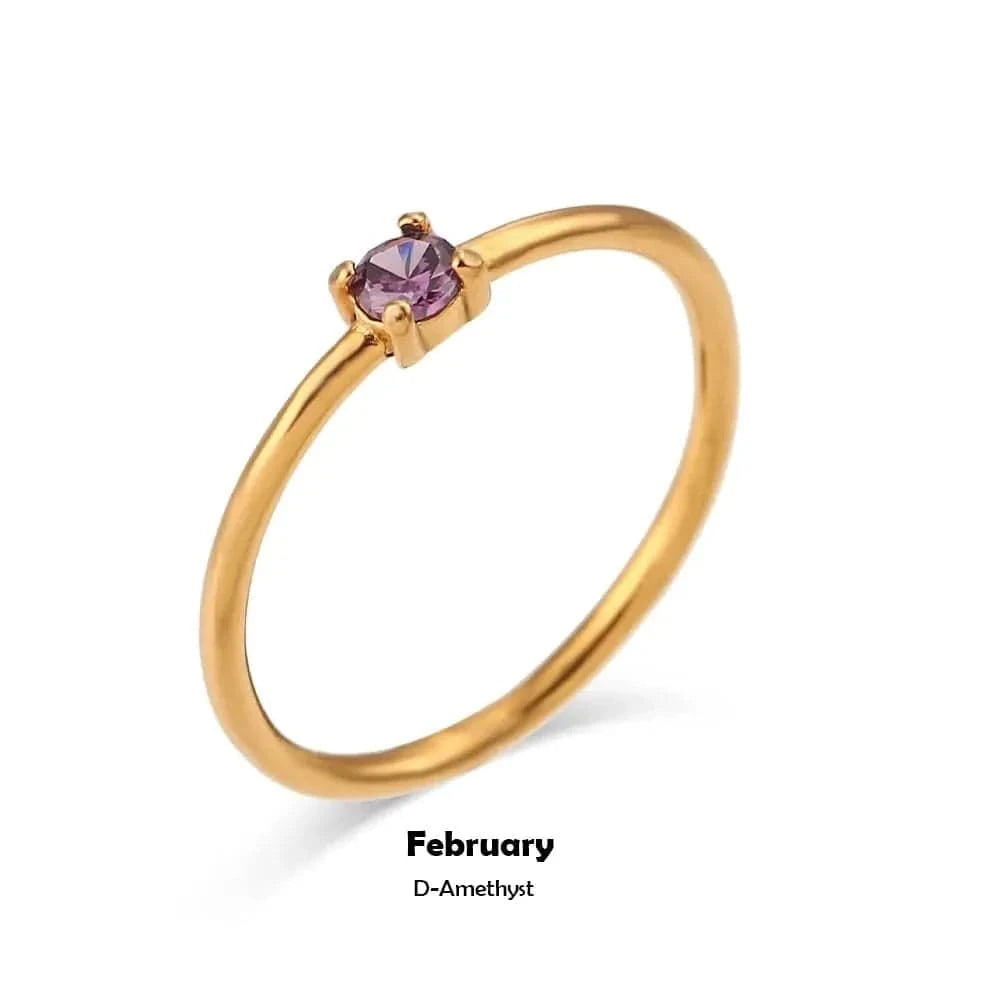 Gold ring with a purple gemstone on a white background, labeled 'February D-Amethyst'.