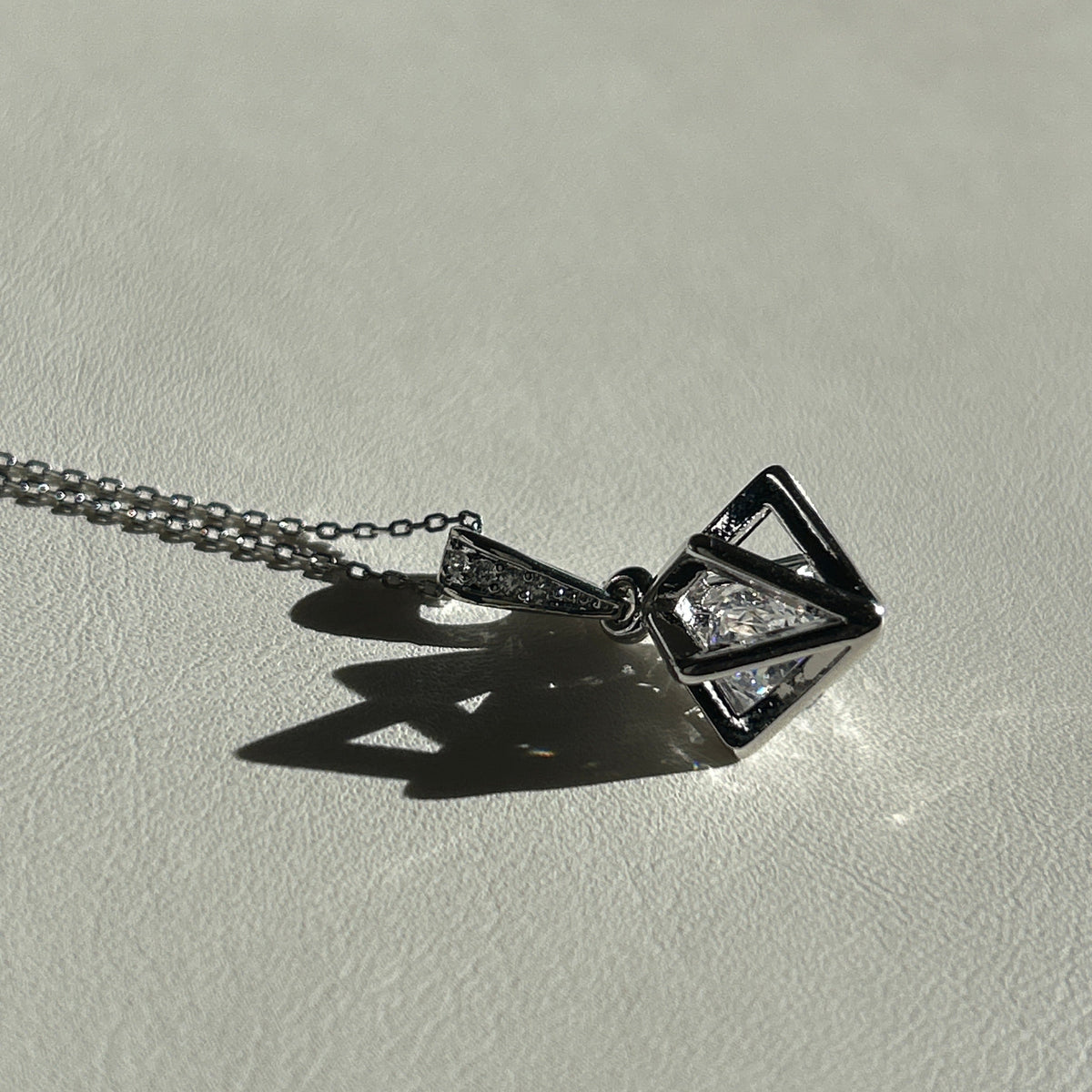 Silver Floating Prism pendant necklace with clear faceted glass bead in an open 3D frame