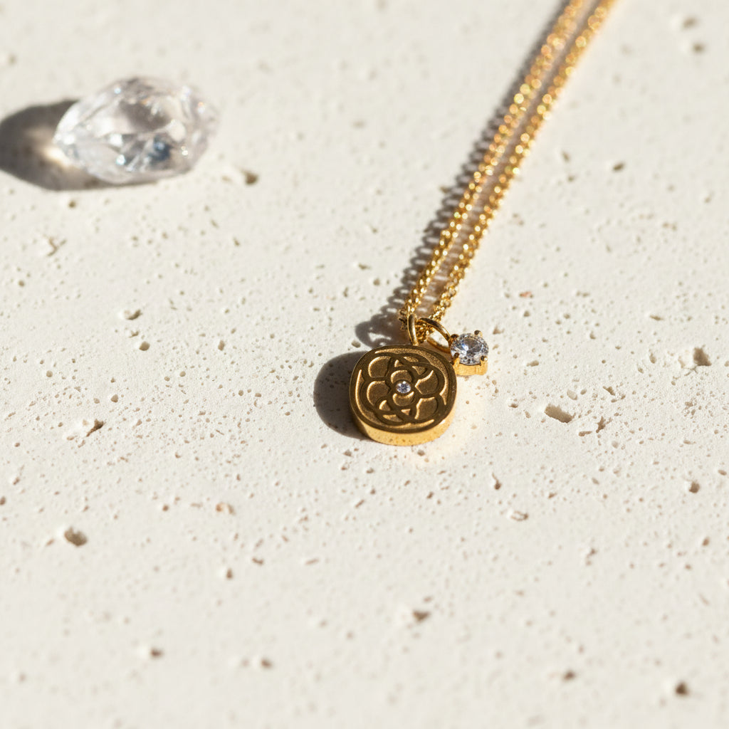 Close-up of the gold floral medallion pendant with its mini cubic zirconia centre