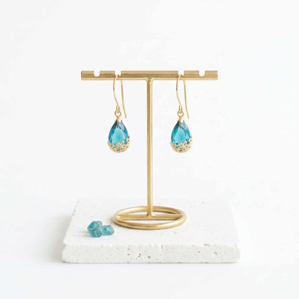 Small gold Flower-Cap earrings with vivid sapphire blue glass drops on shepherd's hooks