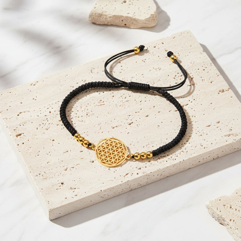 Black cord flower of life bracelet with a gold charm — sacred geometry jewelry for grounding