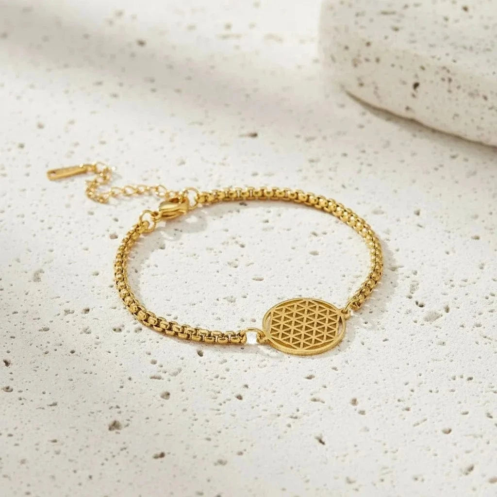 Gold bracelet with a geometric design on a black background