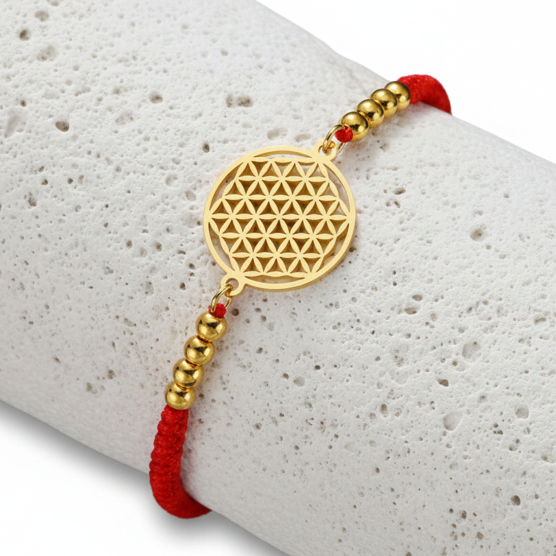 Close-up of the red cord flower of life bracelet — sacred geometry charm detail