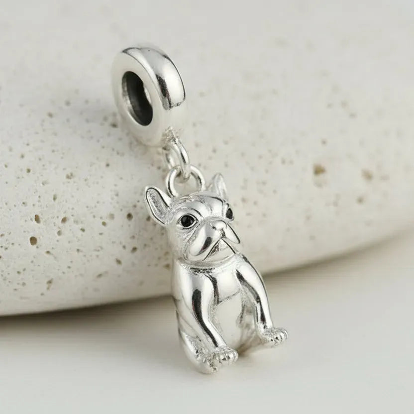 Silver dog-shaped pendant on a white background 