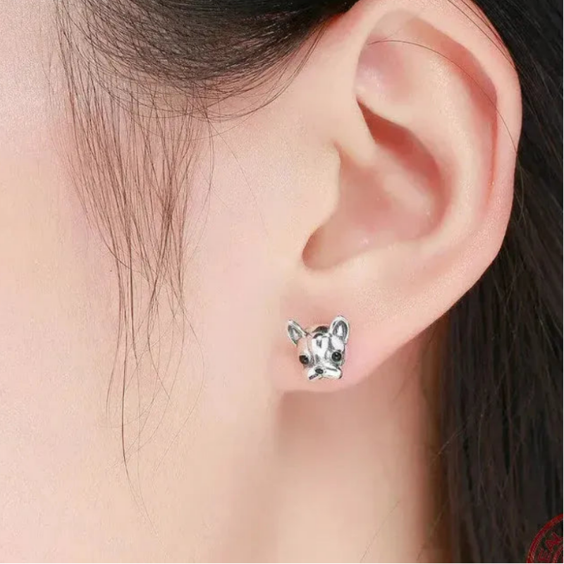 Woman wearing silver dog stud earrings — keepsake necklace for love and rescue