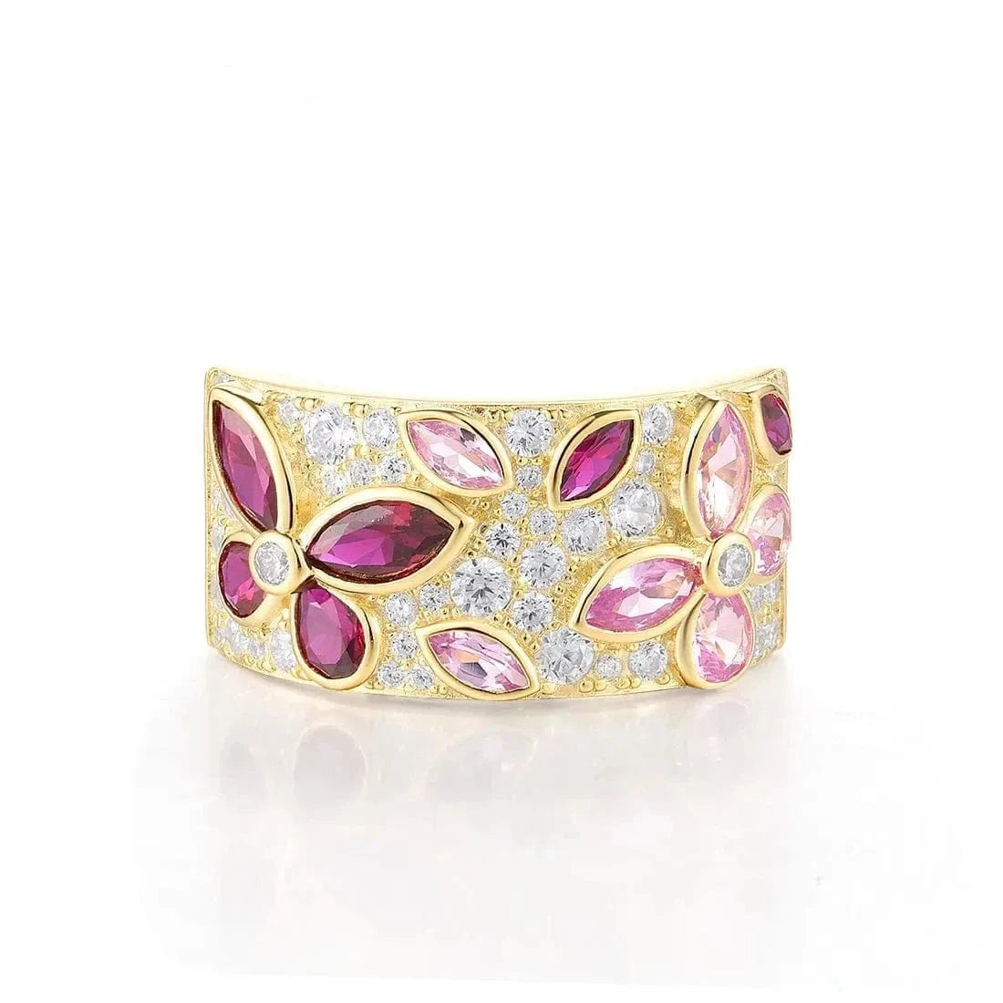 Gold ring with pink and red gemstones on a white background