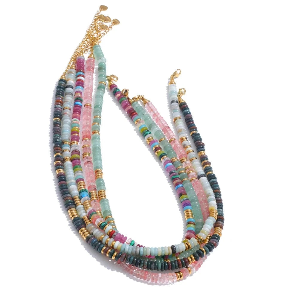Multicolored beaded necklace with gold accents on a white background