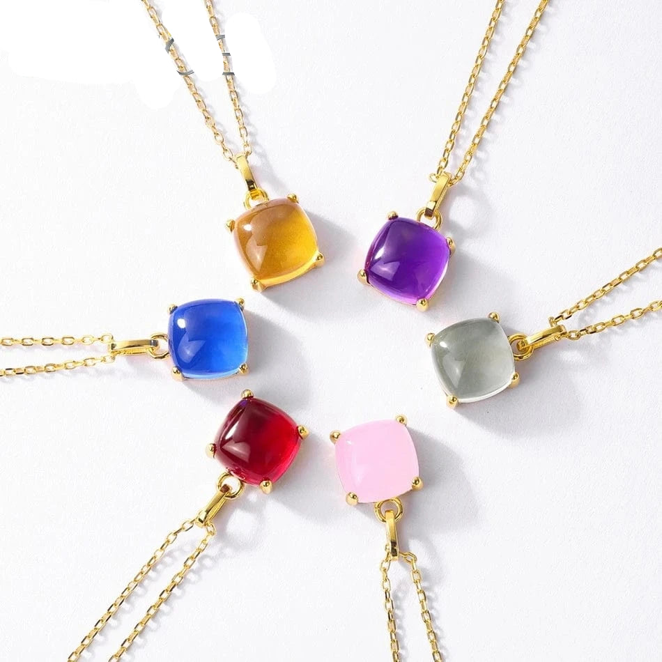 Colorful gemstone necklaces with gold chains on a white background