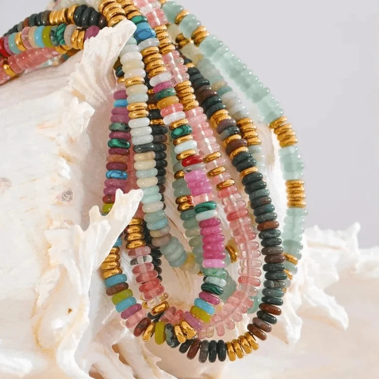 Colorful beaded bracelets on a white shell with a light background