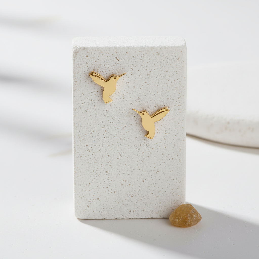 Pair of gold hummingbird stud earrings in waterproof stainless steel
