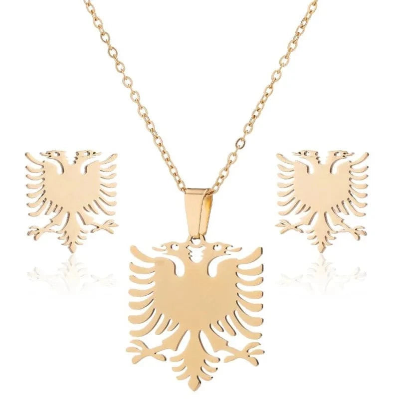 Gold eagle pendant necklace and earrings set on a white background