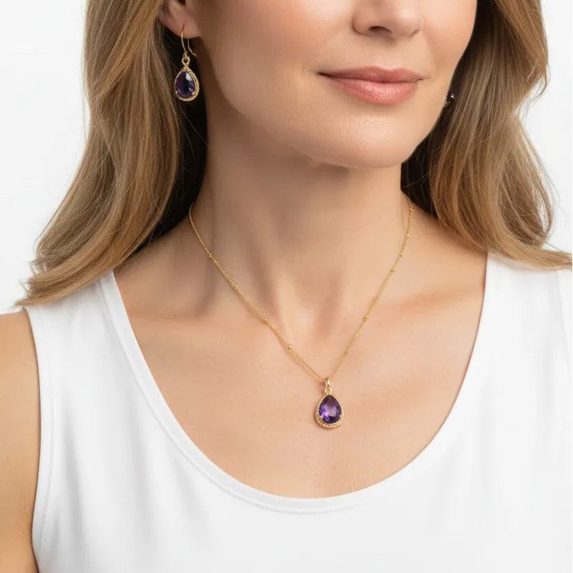 Woman wearing amethyst exquisite drop earrings and necklace in gold, February birthstone jewelry