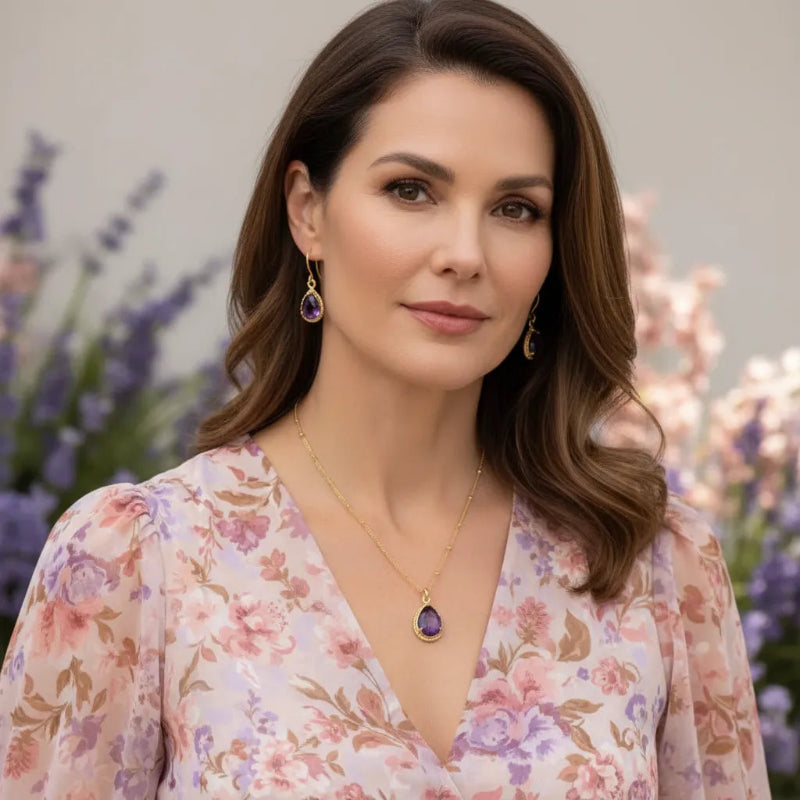 Woman wearing amethyst teardrop pendant necklace in gold, February birthstone jewelry