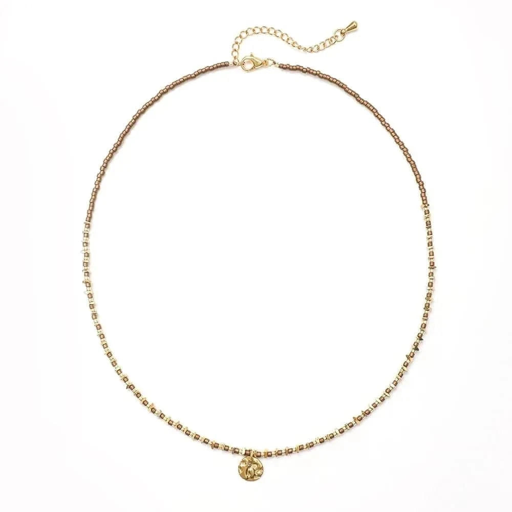 Gold necklace with a small pendant on a white background