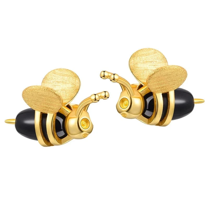 Gold and black bee-shaped earrings on a white background