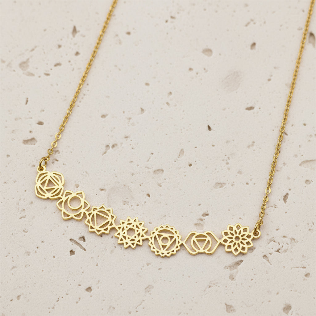 Gold necklace with floral designs on a black background