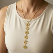 Woman wearing a gold seven chakra yoga necklace — chakra jewelry for balance and alignment