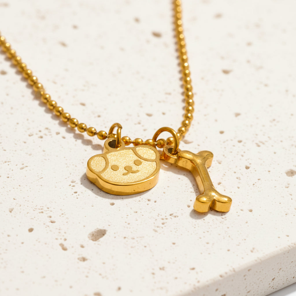 Gold dog bone medallion necklace in stainless steel on a ball chain — Crystals & Paws rescue jewellery for loyalty