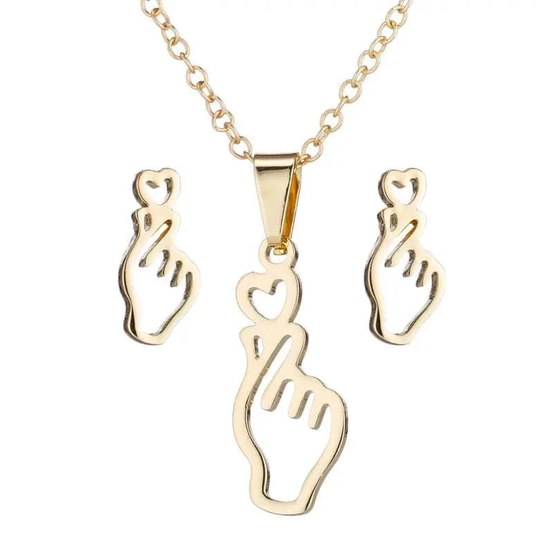 Gold necklace with hand-shaped pendant and matching earrings on a white background