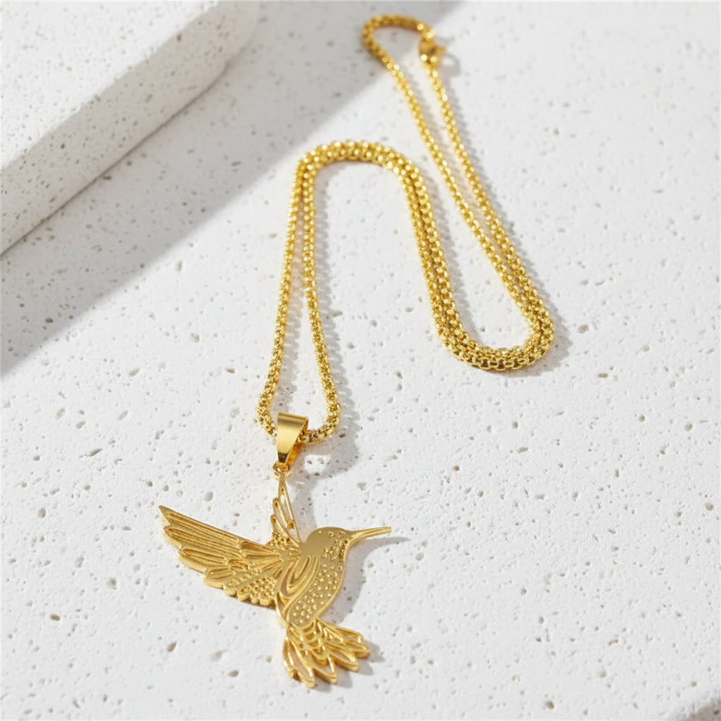 Gold hummingbird pendant necklace — spirit animal jewelry for joy and lightness