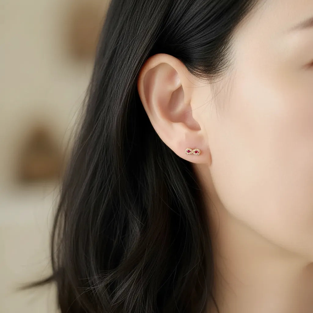 Close-up of an ear wearing a small earring with a blurred background