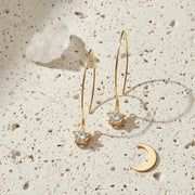 Gold star-shaped earrings on a white background