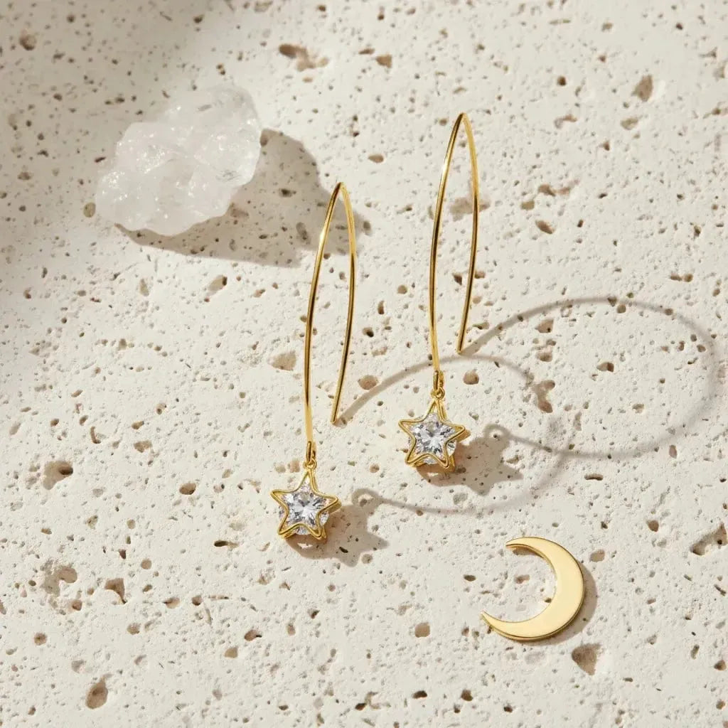 Gold star-shaped earrings on a white background