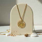 Gold lotus flower medallion necklace — spiritual symbol jewelry for renewal