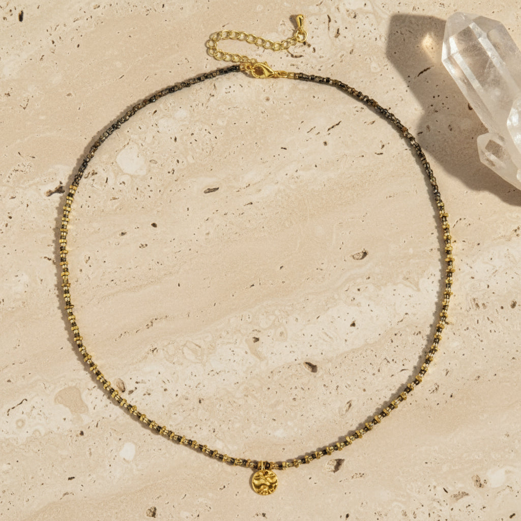 Necklace with gold and black beads on a white background