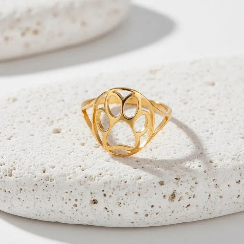Gold ring with geometric design on a white background