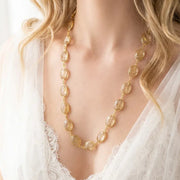 Woman wearing a golden rutilated quartz chain necklace in gold — 30 inch layering necklace