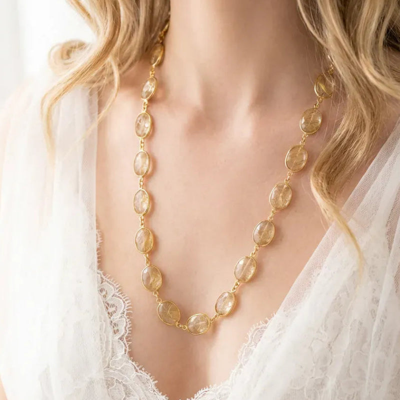 Woman wearing a golden rutilated quartz chain necklace in gold — 30 inch layering necklace