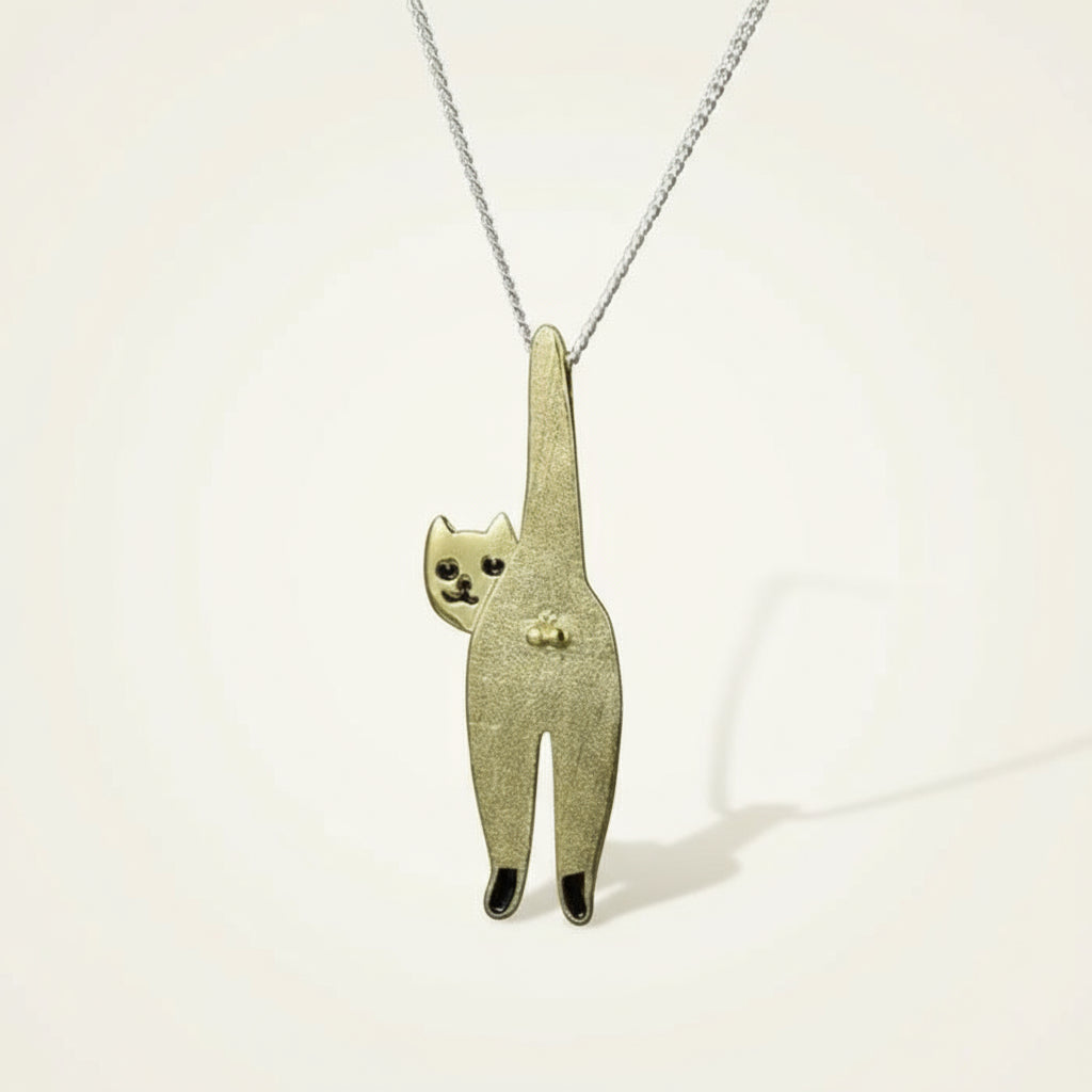 Gold cat-shaped pendant on a gray background