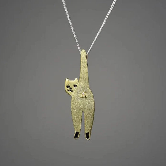 Gold cat-shaped pendant on a gray background