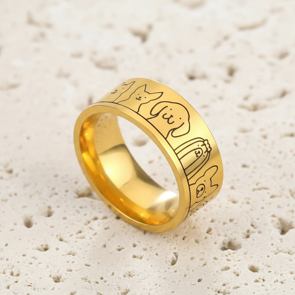 Gold ring with engraved designs on a blue background